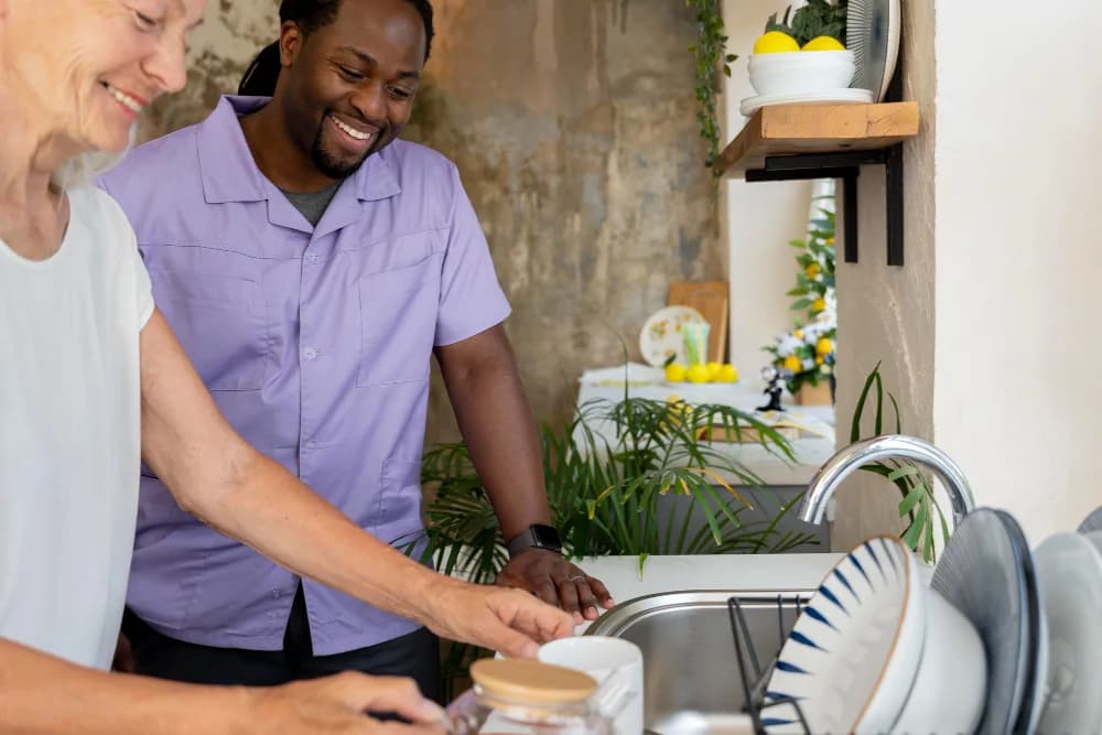 A caregiver helping in a client's kitchen